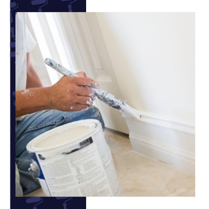 Fine FinishesA person carefully paints white baseboards, using a brush and paint can, on a tiled floor. The scene conveys focus and meticulous attention.